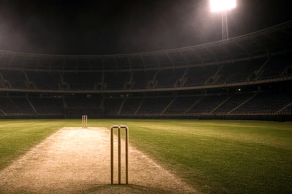 A cricket ground at night on the Crore Bet app page.